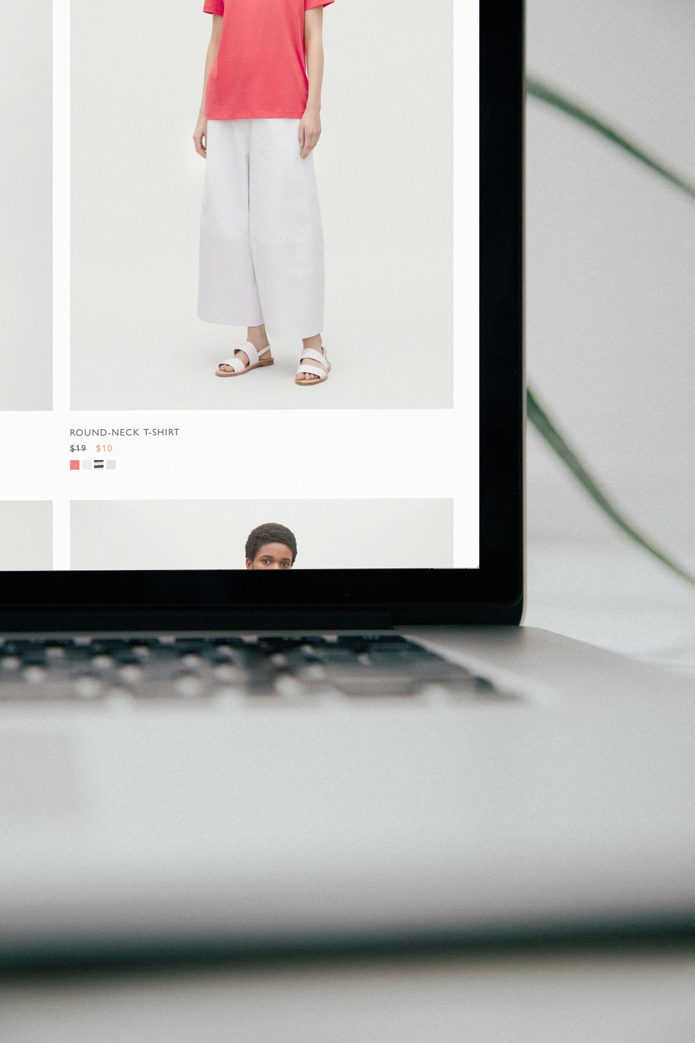 A laptop displaying an online clothing shop.